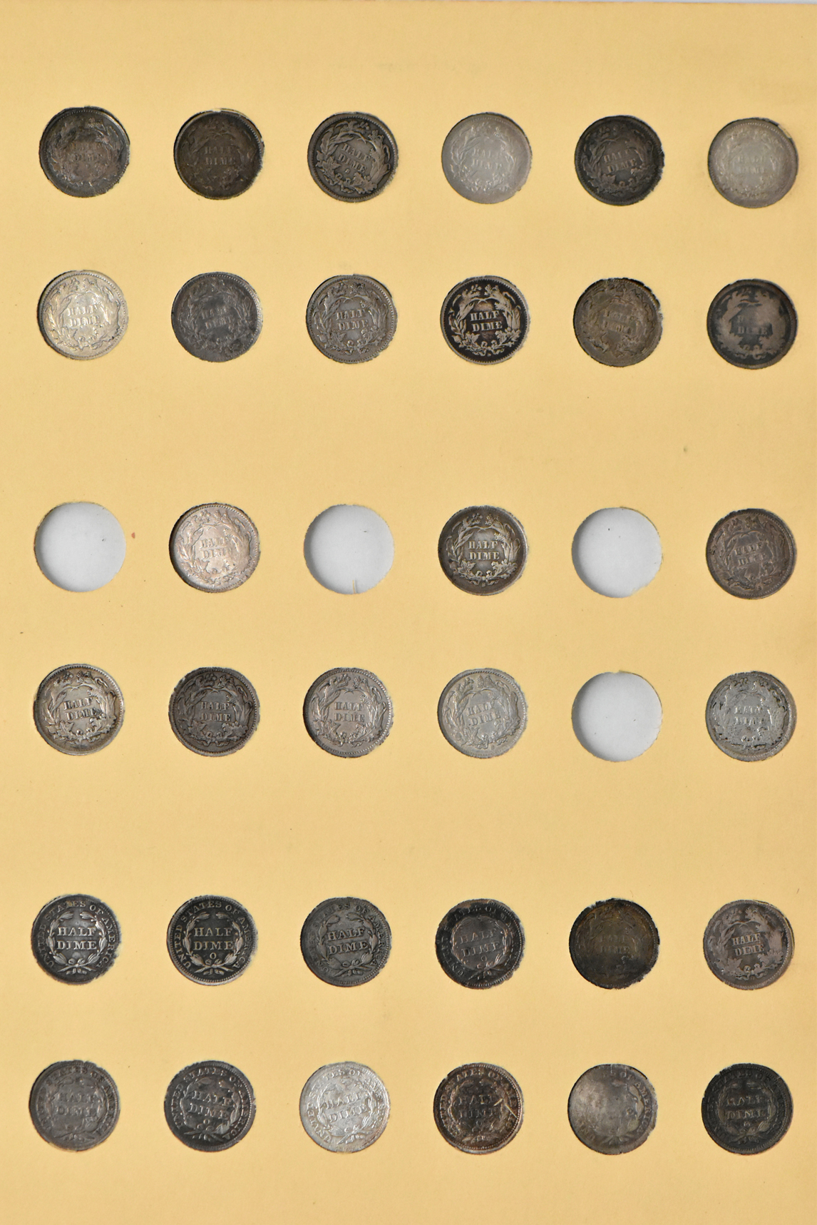 Collection of 86 different half dimes in a Library of Coins Vol. 40 album
