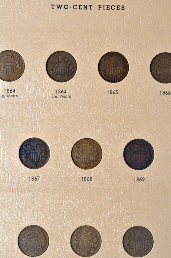 Collection of two-cent pieces, three-cent nickels, and Shield nickels in two Dansco albums
