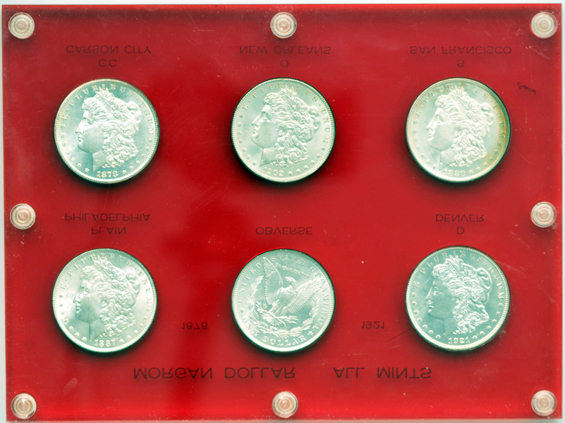 Six Morgan silver dollars in an "All Mints" Capital Plastics holder
