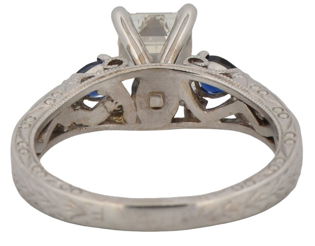 14K White Gold Estate Diamond Ring with a 1.12 Carat Emerald Cut Diamond, I1 Clarity, G Color, GIA #6217263006 with Approximately .25 Carat Total Weight in Round Diamonds and Two Pear Shape Sapphires.