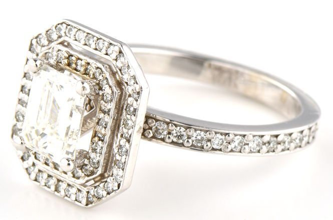 14K White Gold Estate Diamond Ring with a 1.12 Carat Emerald Cut Diamond, I1 Clarity, G Color, GIA #6217263006 with Approximately .25 Carat Total Weight in Round Diamonds and Two Pear Shape Sapphires.
