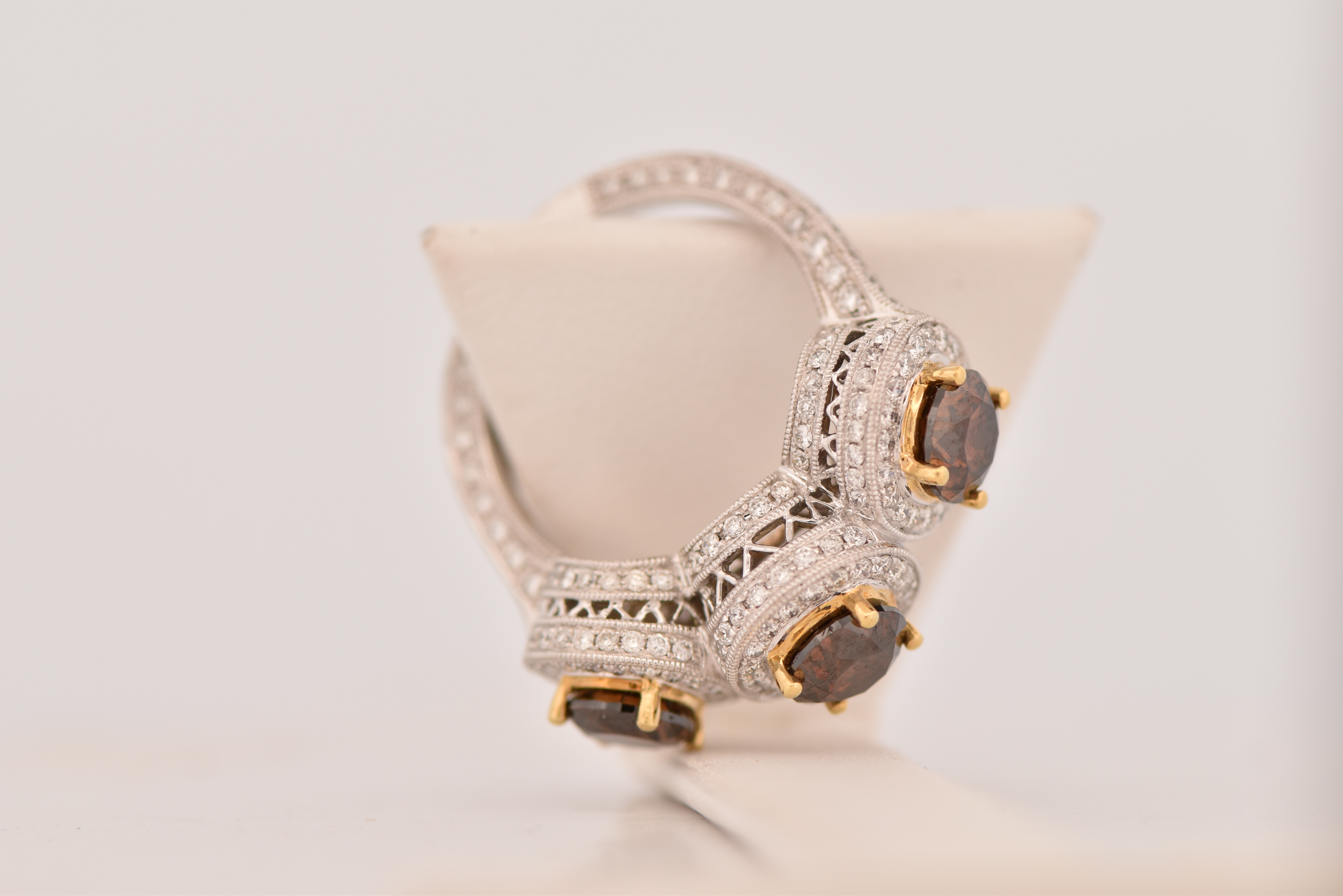 18K White Gold LeVian Diamond Ring with Three Round Chocolate Diamonds, Totaling 3.03 cttw, I1 clarity and 1.36 cttw of Brilliant Cut Round Diamonds, SI Clarity, G-H Color. Ring size 7.25, 6.4 dwt.
