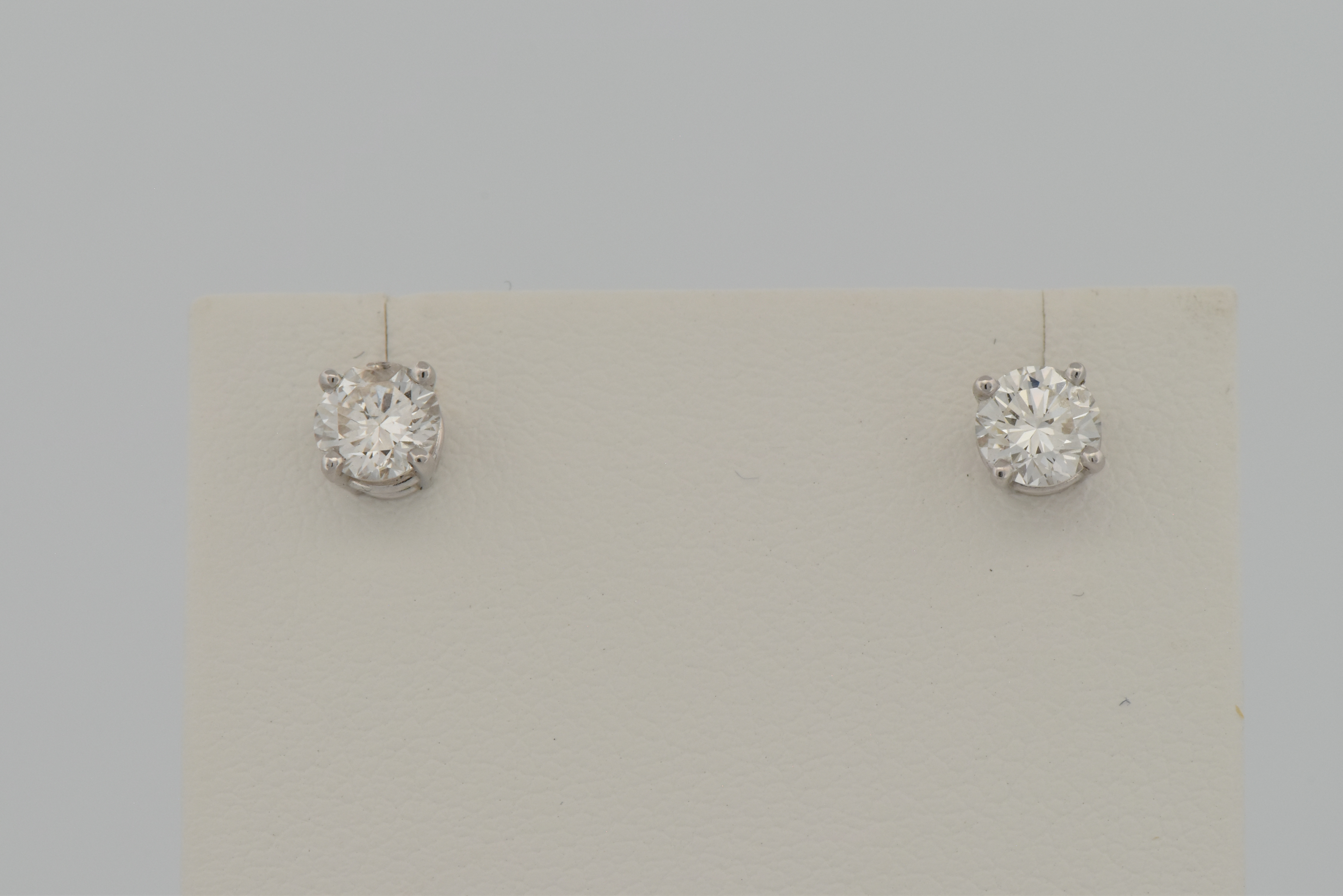 14K White Gold Diamond Stud Earrings with a .48 Carat Round Cut Diamond, SI2 Clarity, H Color, GIA # 6217821536 and a .46 Carat Round Cut Diamond, I1 Clarity, H Color, GIA # 2215821540.
