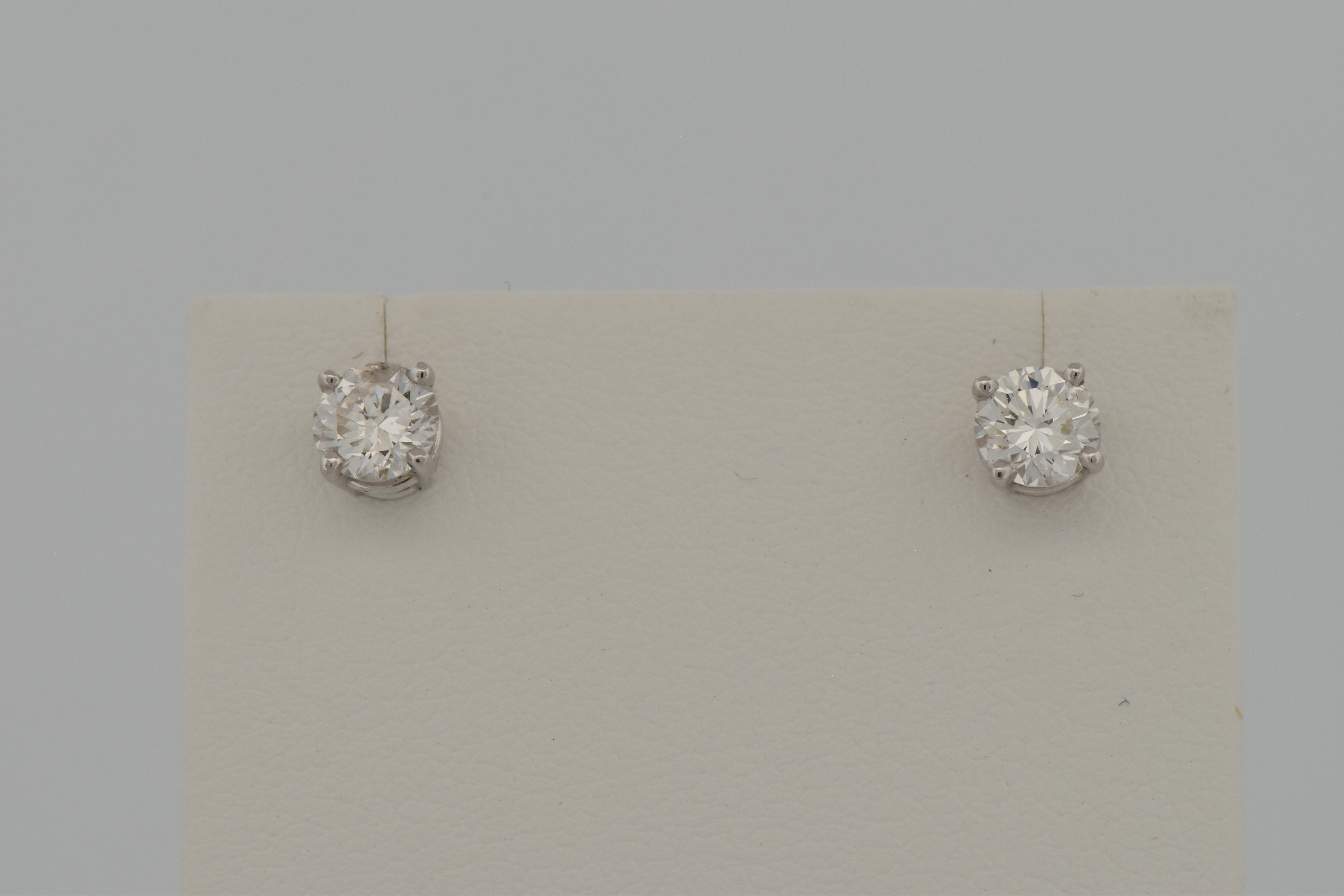 14K White Gold Diamond Stud Earrings with a .48 Carat Round Cut Diamond, SI2 Clarity, H Color, GIA # 6217821536 and a .46 Carat Round Cut Diamond, I1 Clarity, H Color, GIA # 2215821540.