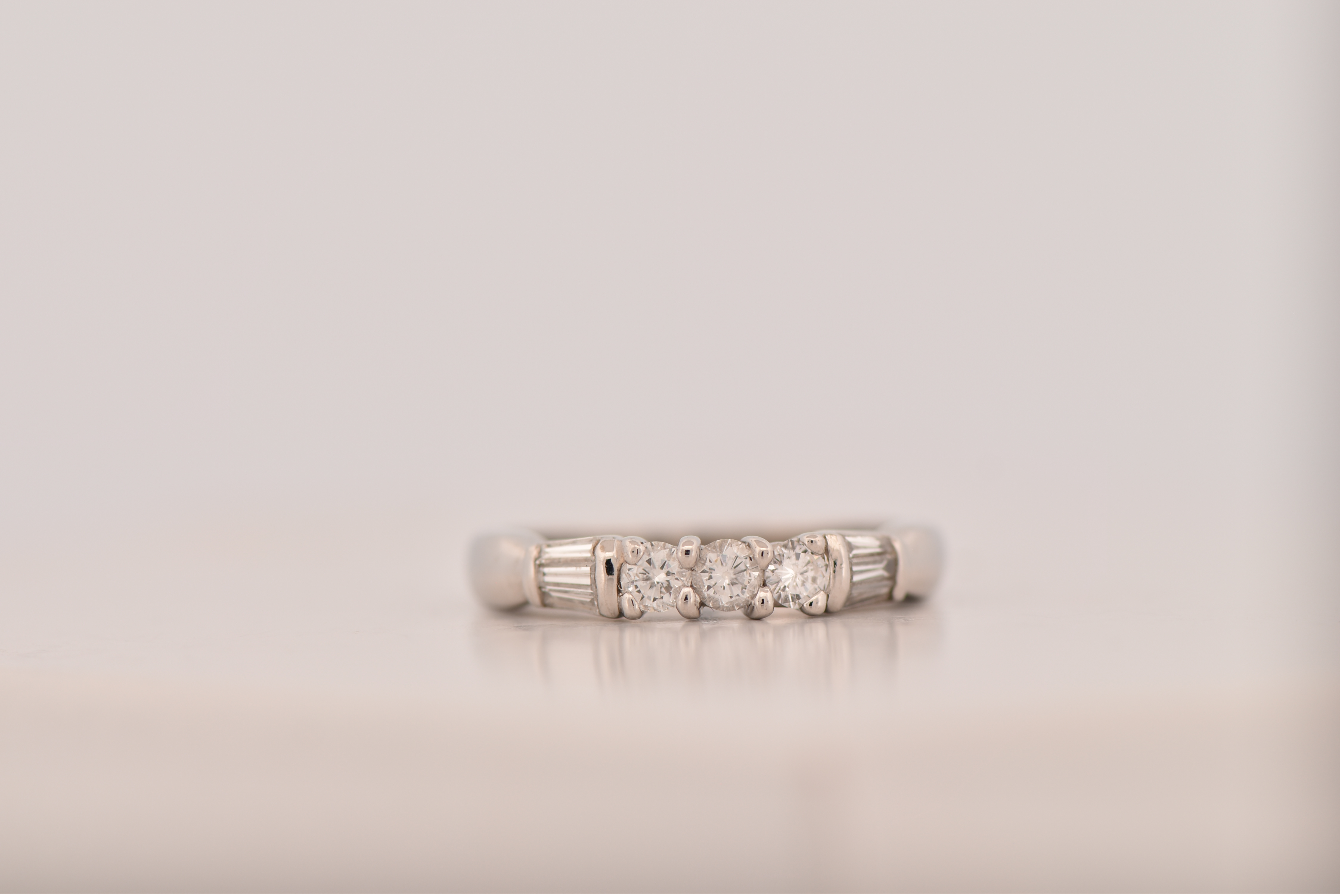 Platinum Estate Diamond Band with Approximately .60 Carat Total Weight in Round and Baguette Cut Diamonds, SI2 Clarity, I-J Color. 4.2 dwt.