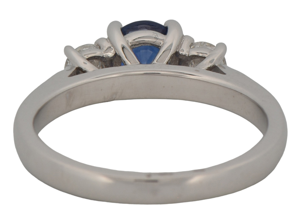 14K White Gold Three Stone Ring with a .85 Carat Round Sapphire Center Stone and Two Side Diamonds Totaling .35 Carat Total Weight in Round Cut Diamonds, SI1 Clarity, G-H Color.