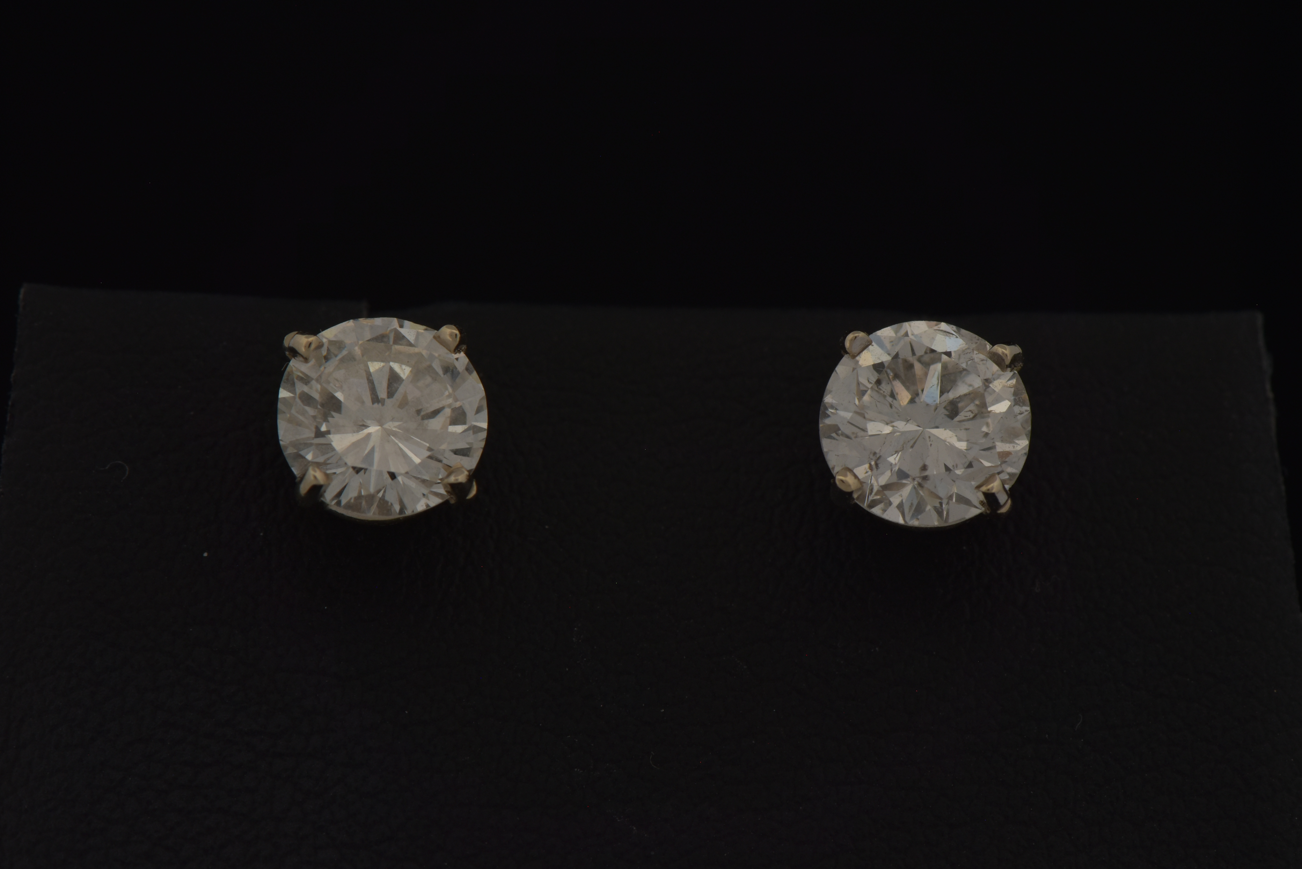 14K White Gold Diamond Stud Earrings with a 1.25 Carat Round Brilliant I1 Clarity, G Color GIA #2225850512 and a 1.09 Carat Round Brilliant, I1 Clarity , H Color GIA #6227646142