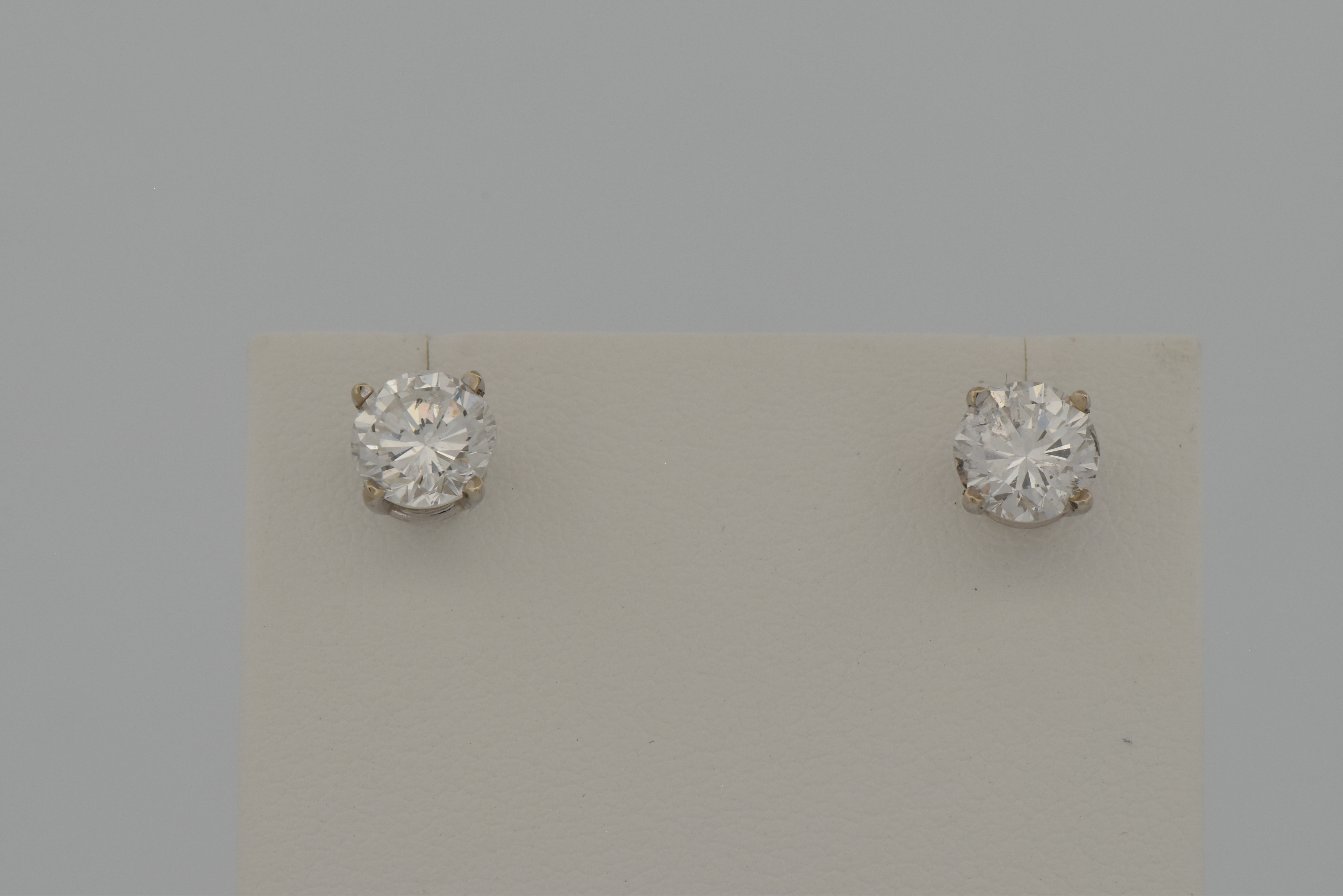 14K Diamond Stud Earrings with a .93 Carat Round Brilliant, I1 Clarity, F Color GIA #5222646123 and a .94 Carat Round Brilliant, I1 Clarity, G Color GIA #2225470606