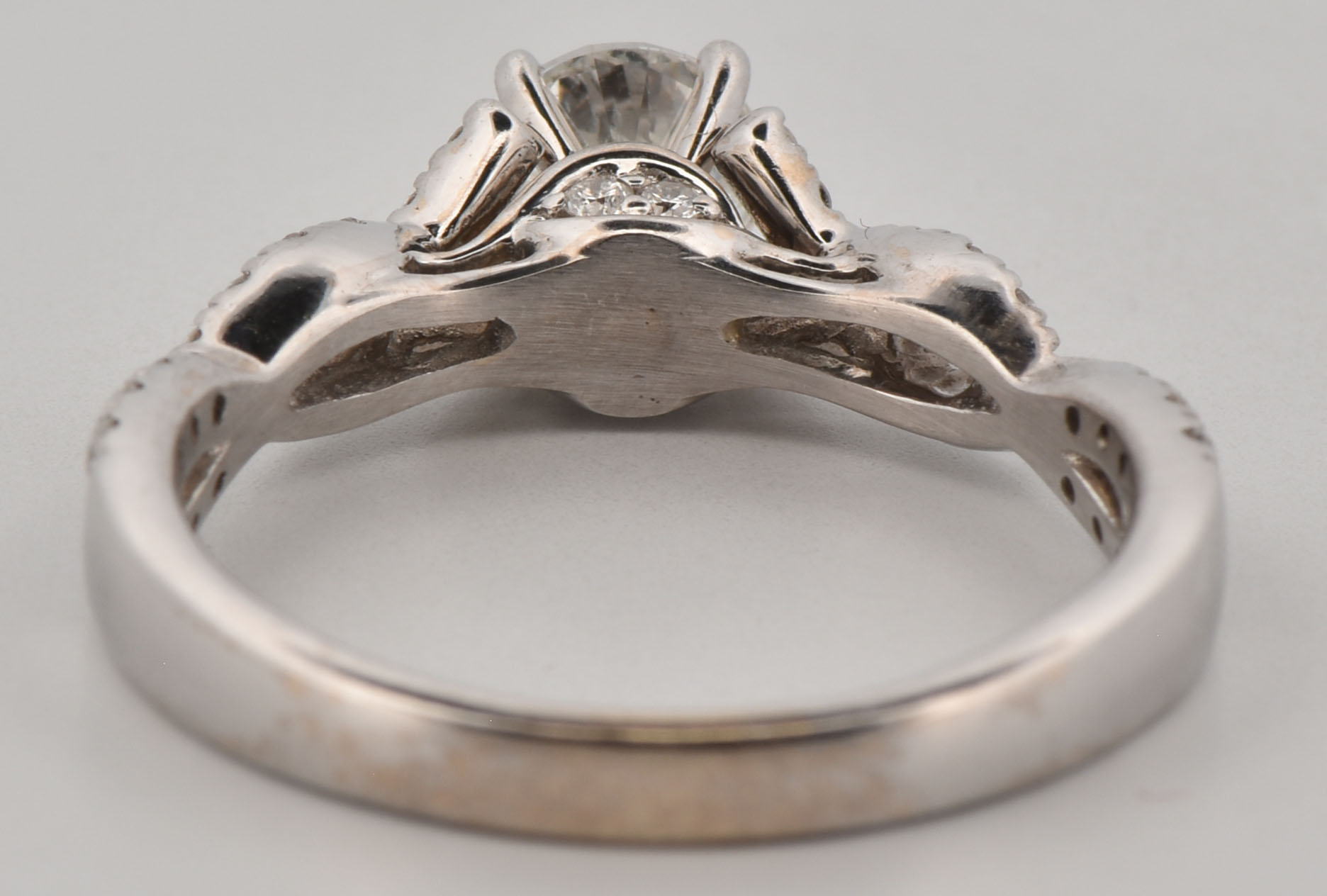 14K White Gold Estate Diamond Ring with an Approximate .60 Carat Round Diamond, I1-2 Clarity, H-I Color with Approximately .40 Carat Total Weight in Side Round Diamonds, SI1 Clarity, H-I Color.