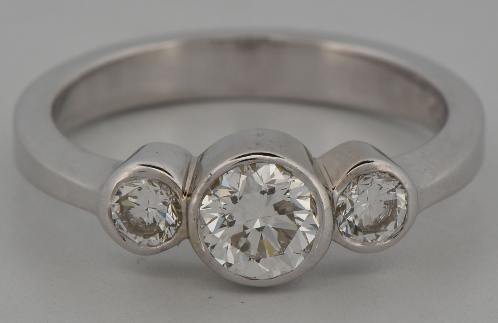 18K White Gold Estate Three Stone Diamond Ring with an Approximate .50 Carat Round Cut Diamond and Two Side Round Diamonds Totaling Approximately .15 Carat Total Weight, VS Clarity, I-J Color. 2.7 dwt