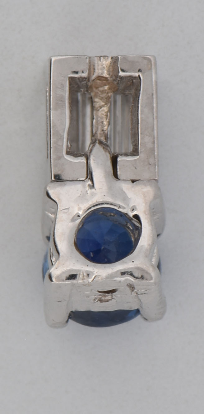 14K White Gold Pendant with an Approximate .50 Carat Round Violetish Blue Sapphire and Approximately .15 Carat Total Weight in Baguette Diamonds, VS Clarity, H Color