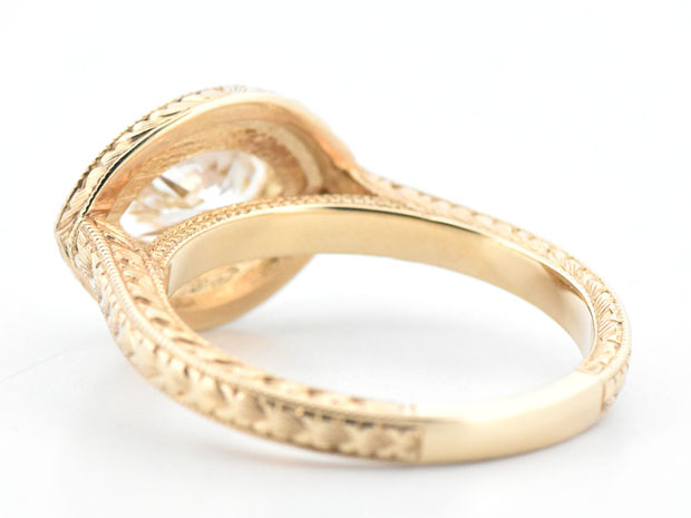 14K Yellow Gold Diamond Ring with a 1.01 Carat Marquise Diamond, SI1 Clarity, K Color GIA #5234334495 and .25 Carat Total Weight in Side Round Diamonds, SI Clarity. G-H Color