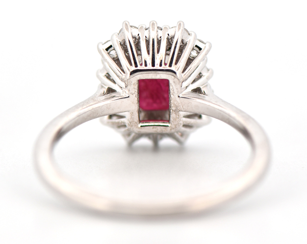 14K White Gold Ruby and Diamond Halo Ring with a 1.51 Carat Emerald Cut Ruby and .35 Carat Total Weight in Round Cut Side Diamonds, SI1 Clarity, G-H Color.