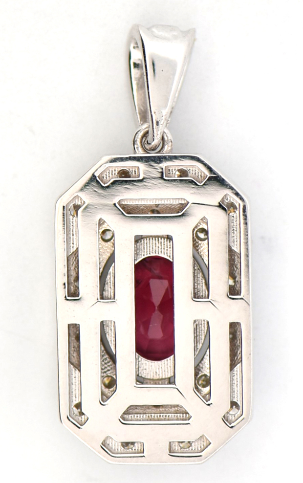 A vintage style pendant with a 1.03 ct. oval red spinel measuring 6.98 x 5.08 x 3.54mm, indications of thermal enhancements, Stone Group Laboratories Report #240418E-SJ. There is .58 cttw of round bri