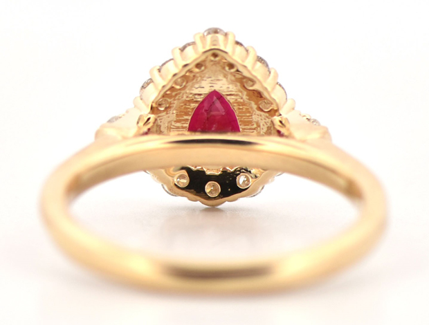 14K Yellow Gold Diamond and Ruby Ring with a 1.29 Carat Pear Ruby and .51 Carat Total Weight in Side Diamonds, SI Clarity, G Color