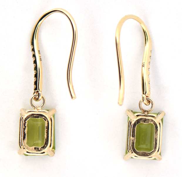 14K Yellow Gold Peridot and Diamond Dangle Earrings with Two 8x6mm AA Quality Emerald Cut Peridots and .09 Carat Total Weight in Round Cut Diamonds. 1.4 dwt.